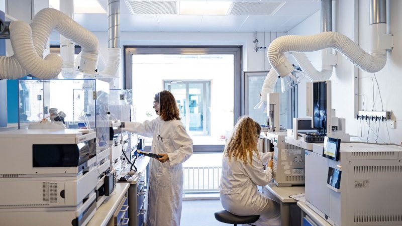 two women scientists are working at separate stations